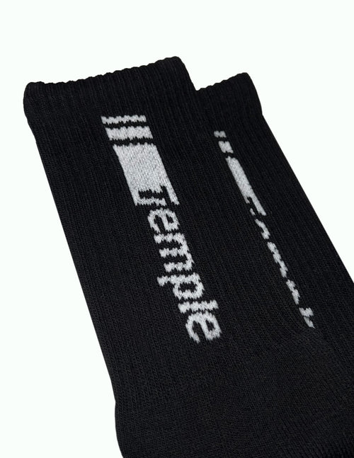 Soft Temple® Sports Socks. Ideal socks for everybody. Put your sneakers on and rock these comfortable soft socks above it. White "Racer" logo on black cotton. Logo applied on every side of the sock. And a white TT logo on the top/toes. Ribbed cuffs and stretch bands for nice and comfortable fit and feeling. We also have the Temple® Racer Sports Socks in the color white. You can find them in the webshop. Sold as one pair as a one size product.
